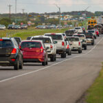 Long line of cars and trucks backed up on a 290