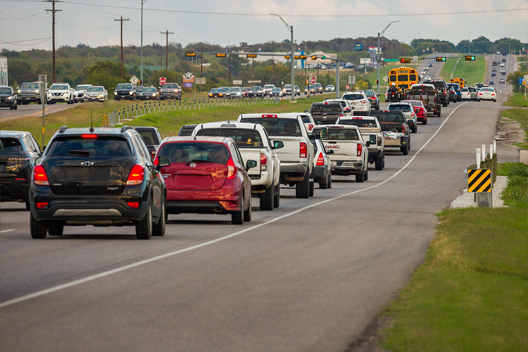 Long line of cars and trucks backed up on a 290