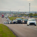 Dense traffic jam on 290 with vehicles extending into the distance under overcast skies