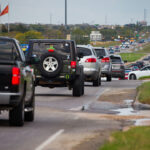 Traffic backup on 290 with emergency vehicles and "No Trucks" signage visible