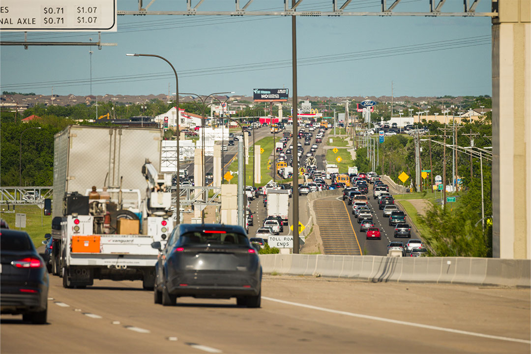 Elevated view of traffic congestion with toll pricing signage visible in foreground