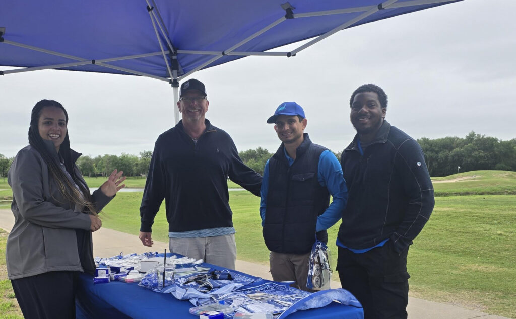 Attendees of the Manor Chamber of Commerce Golf Tournament at the290 Extension Project booth.